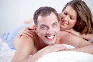happy man and woman in bed
